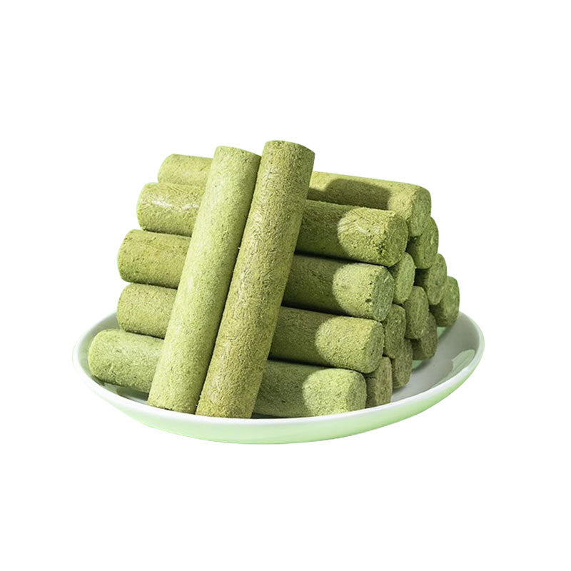 Green cylindrical Cat Grass Sticks on a white plate with a white background